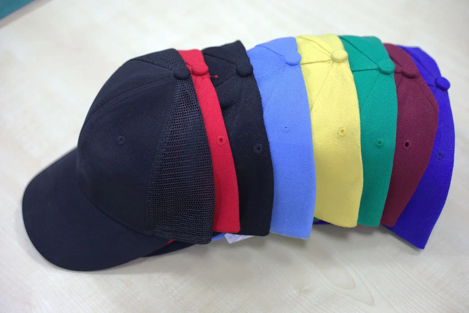 Custom caps in navy, red, blue, gold and green