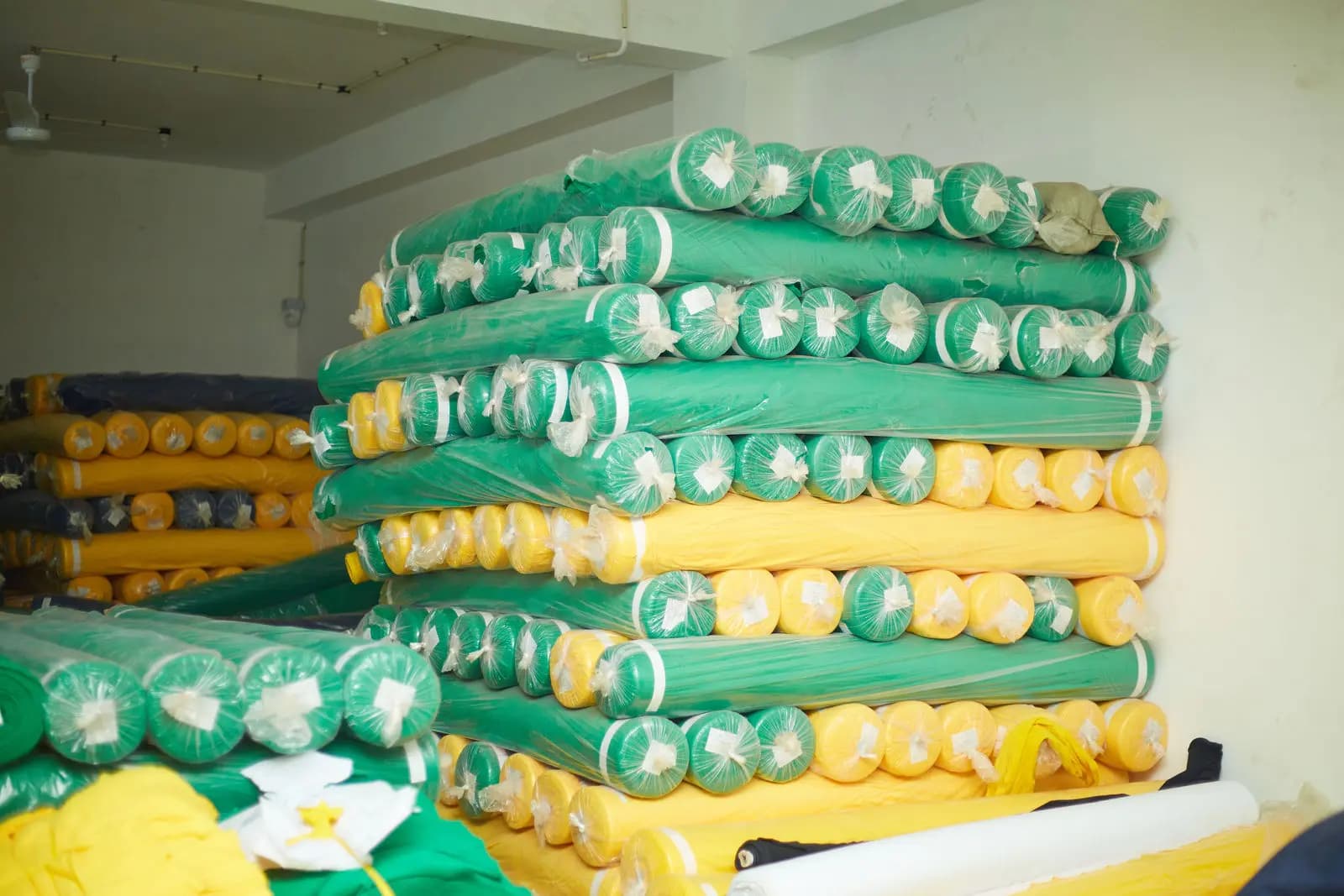Rolls of knitted fabric stacked in the factory store