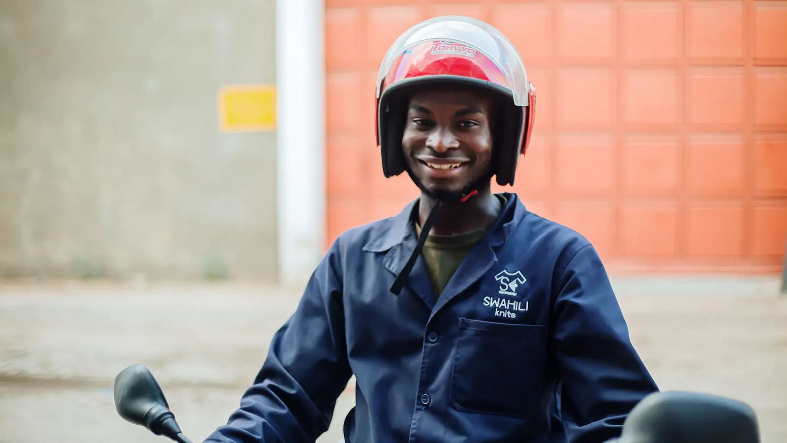 Worker in a safety helmet and branded coverall