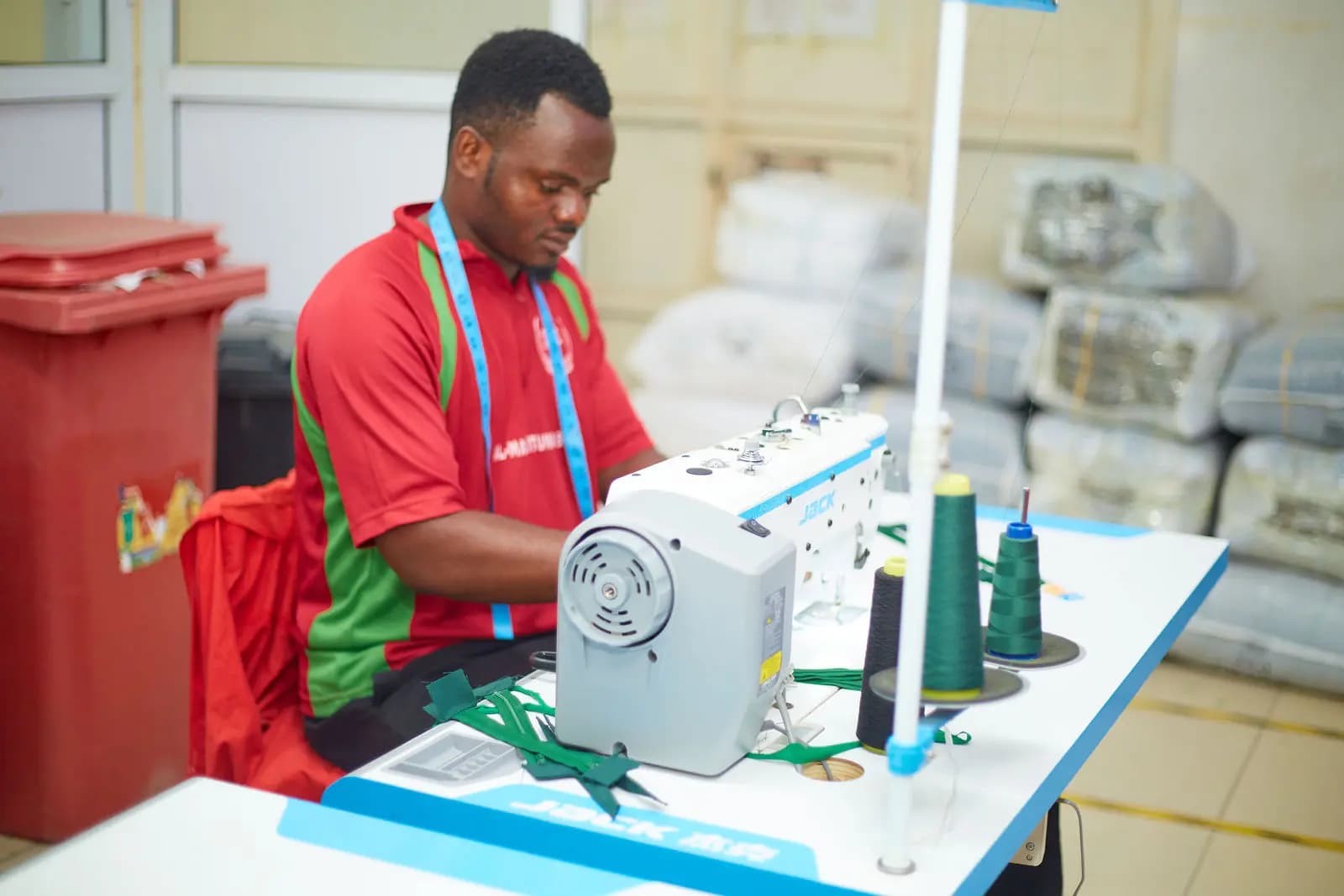 Machinist at his workstation stitching a garment