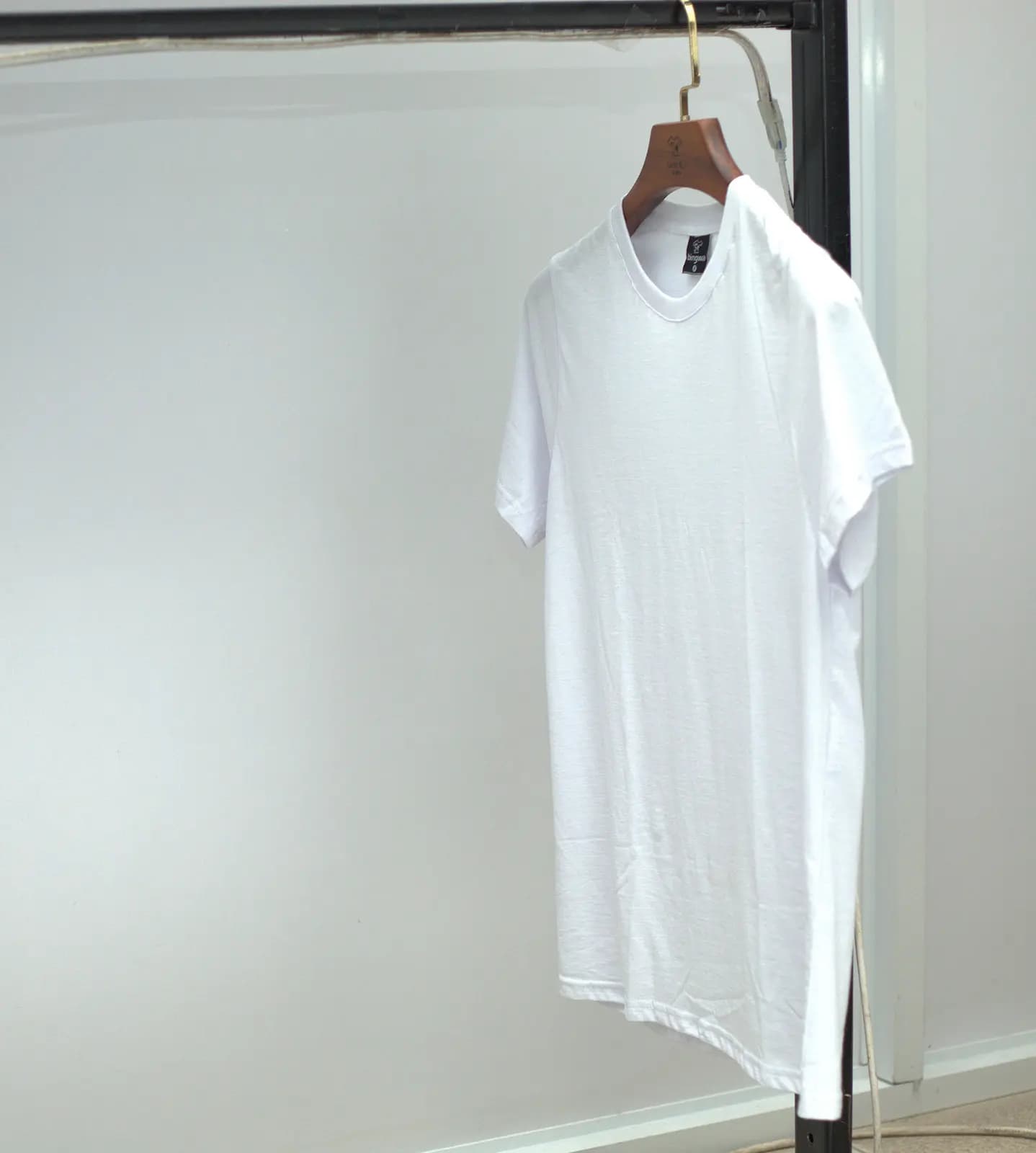 Plain white cotton t-shirt on a hanger