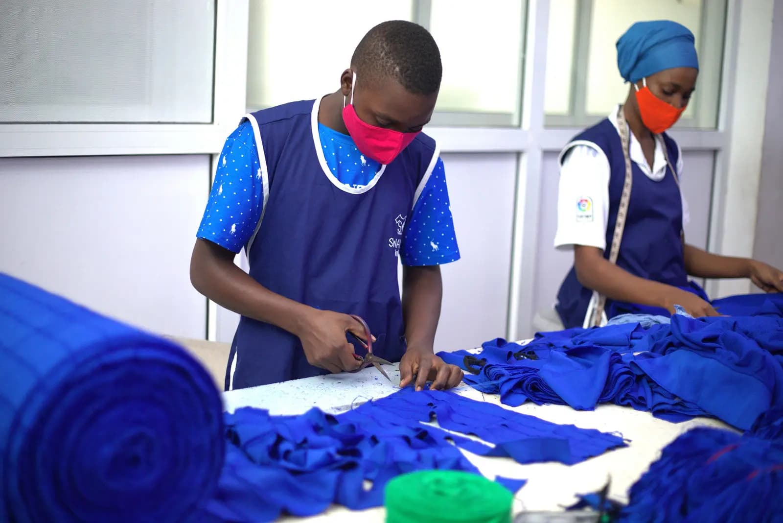 Staff in Swahili Knits uniform at the packing bench