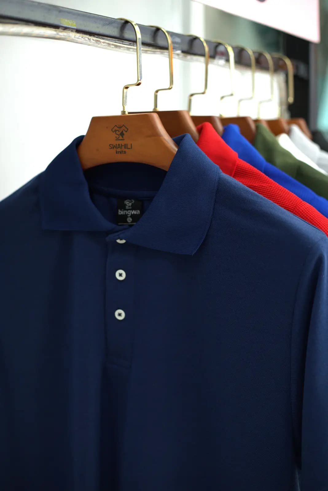 Navy polo shirt on a hanger
