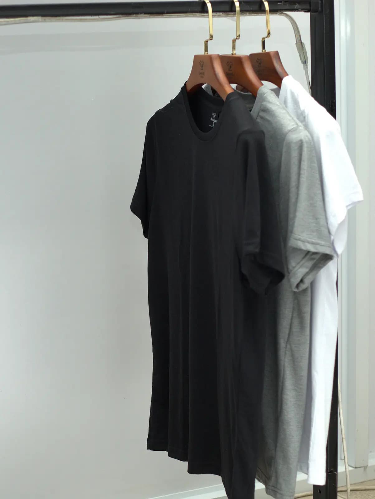 Black t-shirts hanging on the rail